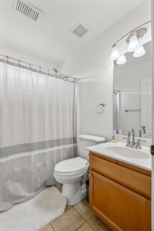 bathroom with vanity, walk in shower, tile patterned floors, and toilet