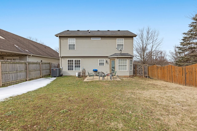 rear view of house with cooling unit, a yard, and a patio