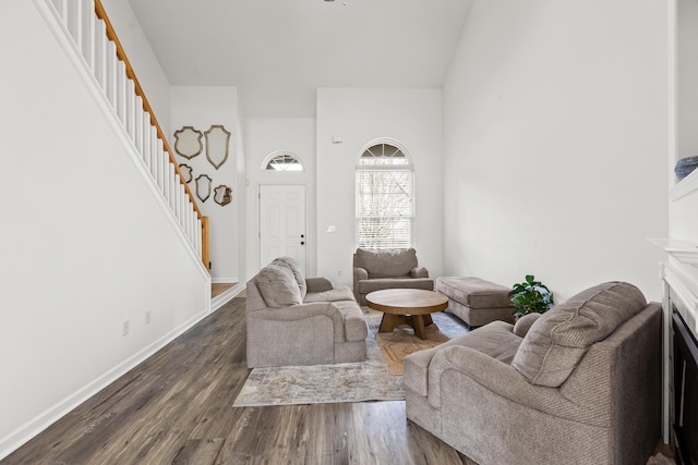 living room with dark hardwood / wood-style floors and high vaulted ceiling