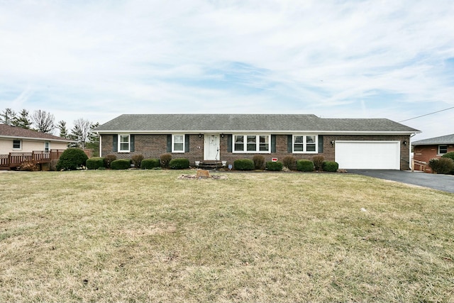 ranch-style house featuring a garage and a front lawn