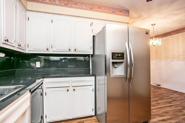 kitchen featuring white cabinetry, dishwasher, and stainless steel fridge