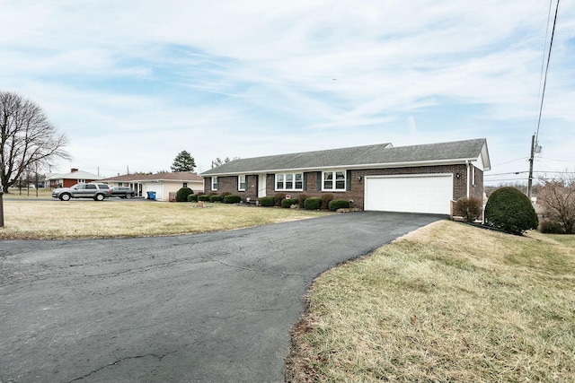 single story home featuring a garage and a front yard