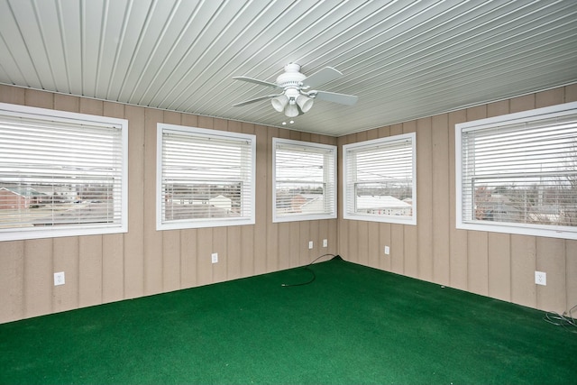 unfurnished sunroom featuring ceiling fan