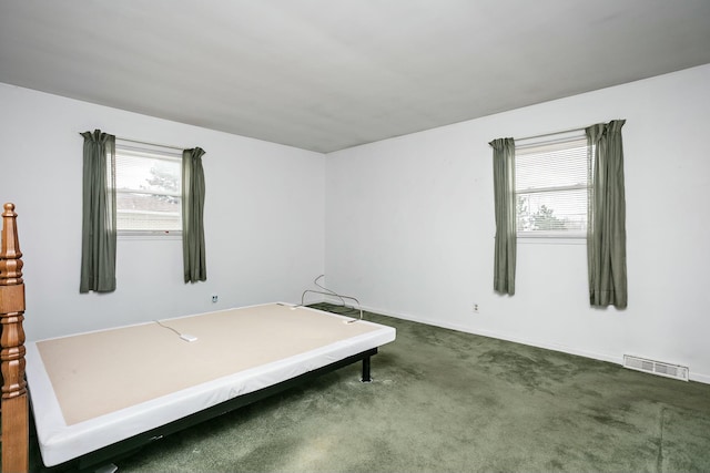 bedroom with dark colored carpet