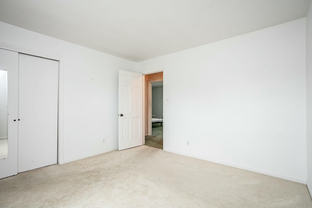 interior space with a closet and light carpet