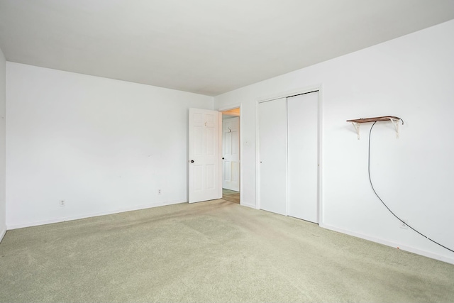 unfurnished bedroom featuring carpet flooring and a closet