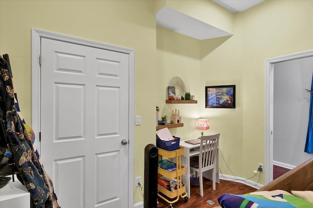 bedroom with dark hardwood / wood-style flooring