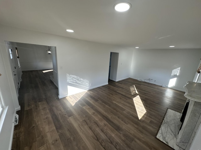 unfurnished room with dark wood-type flooring