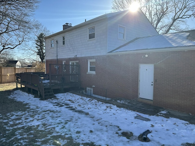 snow covered property featuring a deck