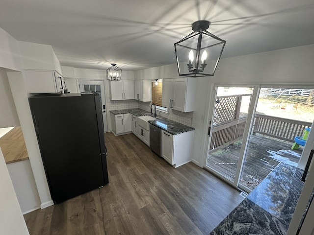 kitchen featuring pendant lighting, white cabinetry, dishwasher, a chandelier, and black fridge