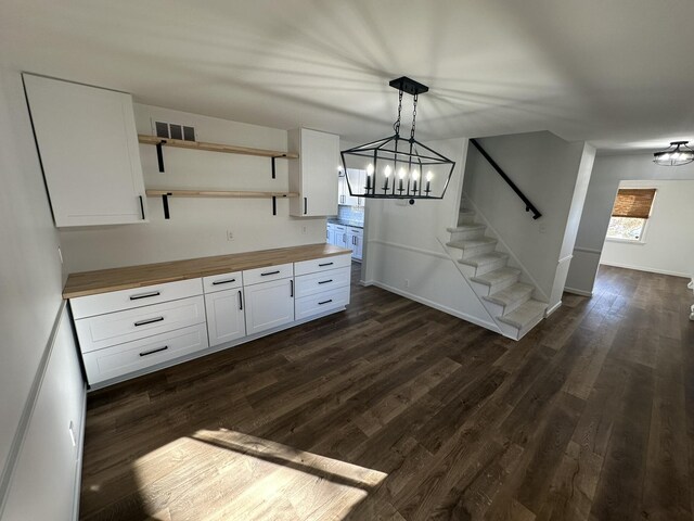 kitchen with white cabinetry, a chandelier, dark hardwood / wood-style flooring, and decorative light fixtures