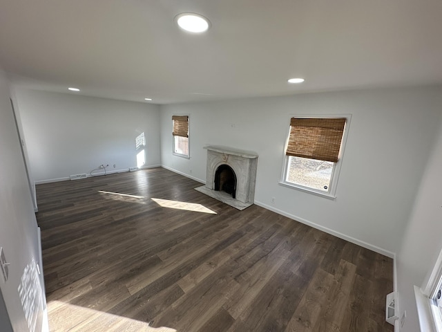 unfurnished living room featuring dark hardwood / wood-style floors and a fireplace