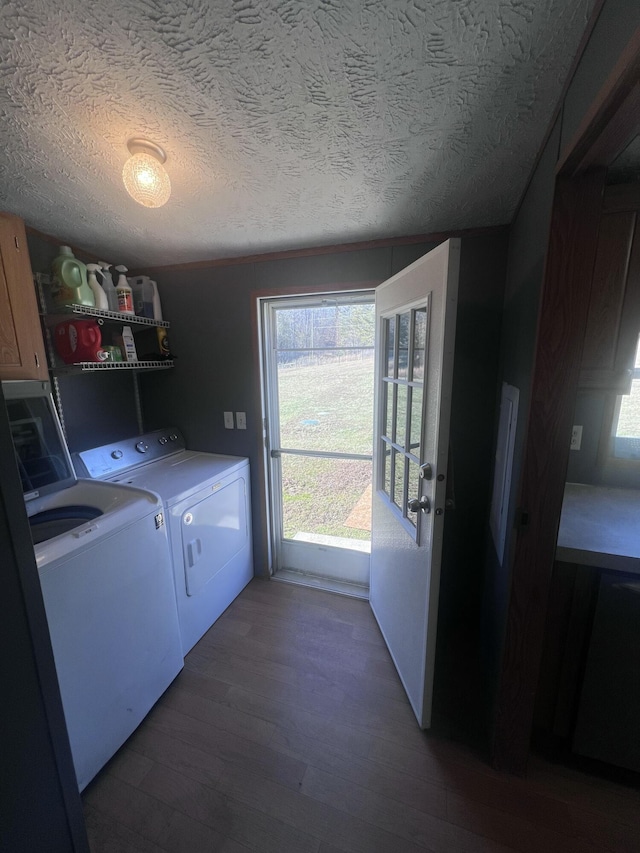 laundry area featuring dark wood-type flooring, washer and dryer, and a textured ceiling