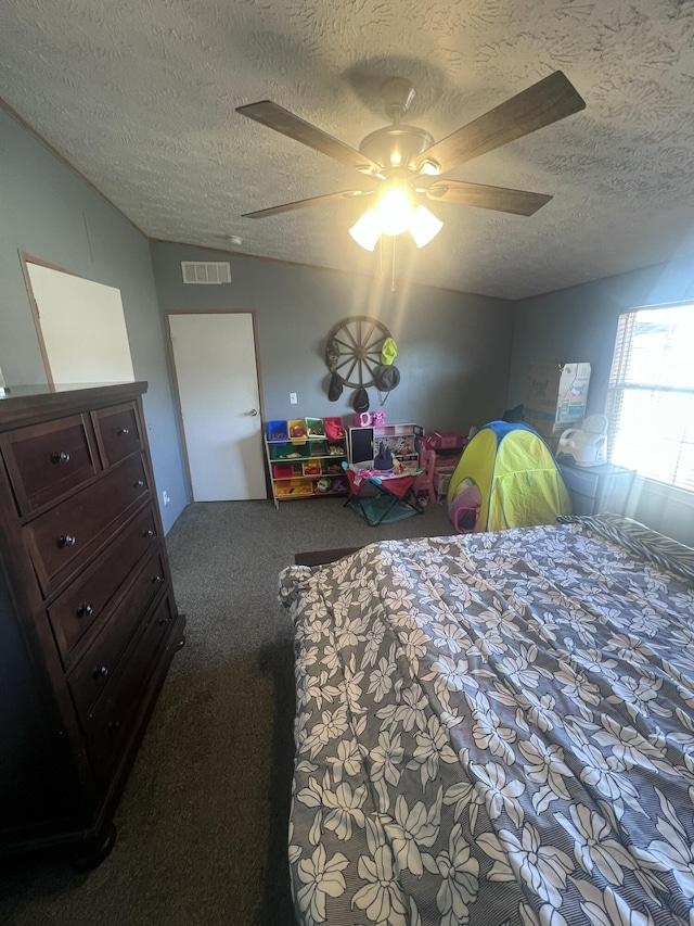 bedroom featuring a textured ceiling, ceiling fan, and carpet