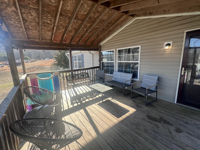 wooden deck with an outdoor living space