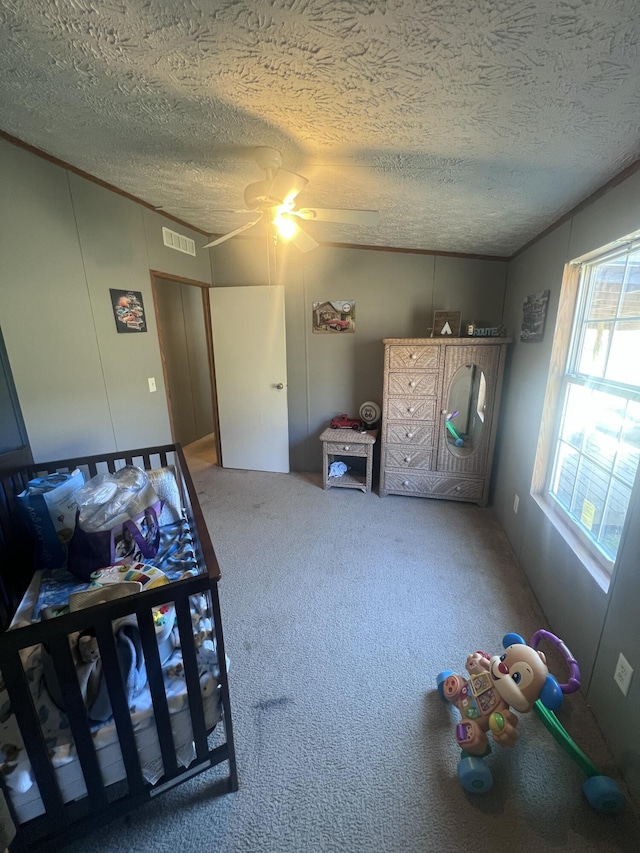 carpeted bedroom with a textured ceiling and ceiling fan