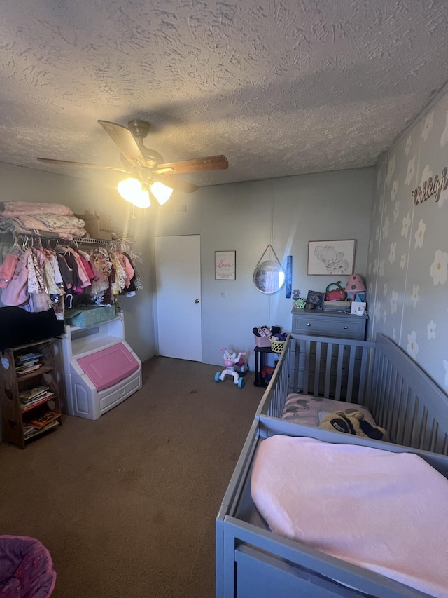 bedroom with ceiling fan, carpet, and a textured ceiling