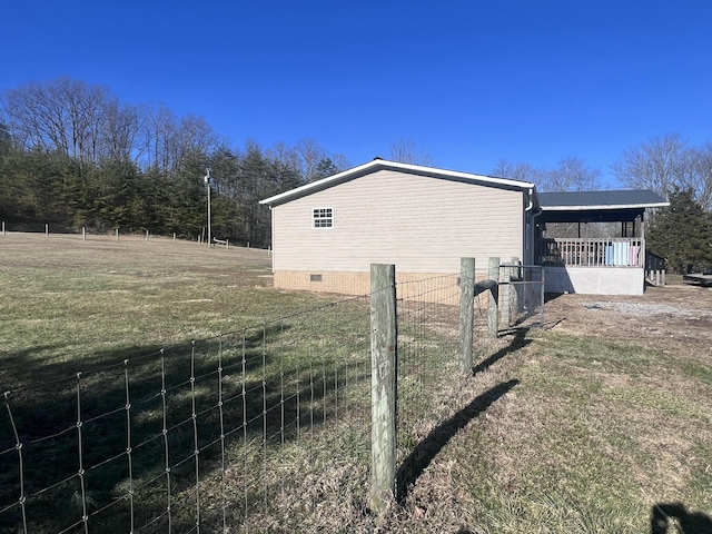 view of side of property with a lawn