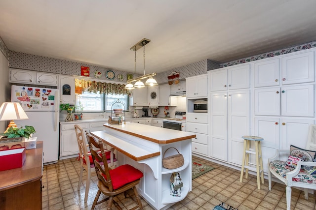 kitchen featuring white cabinetry, hanging light fixtures, white appliances, and a kitchen island