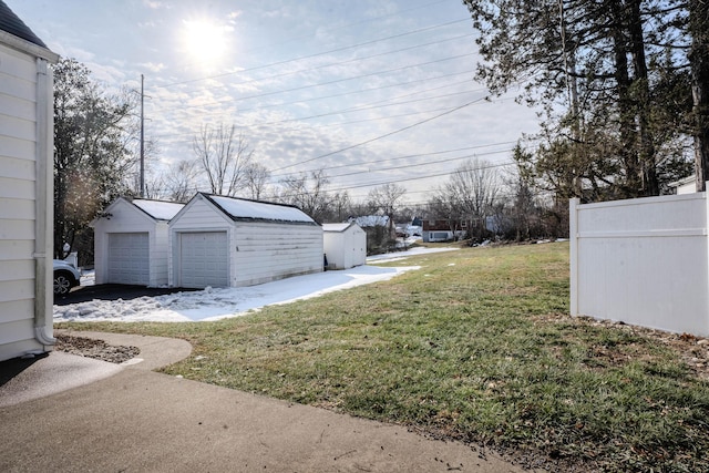 view of yard featuring an outbuilding and a garage