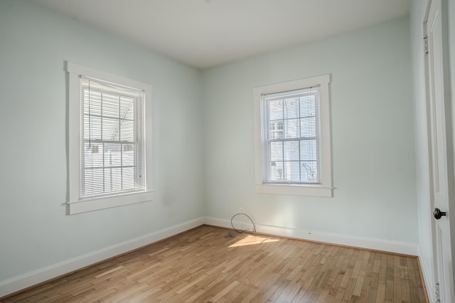 spare room with light wood-type flooring