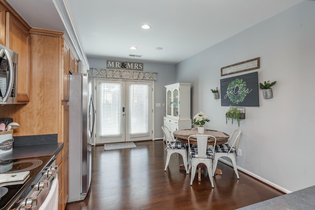 dining area with dark hardwood / wood-style floors and french doors