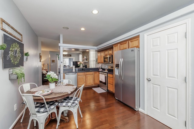 kitchen with sink, decorative backsplash, dark hardwood / wood-style floors, and appliances with stainless steel finishes