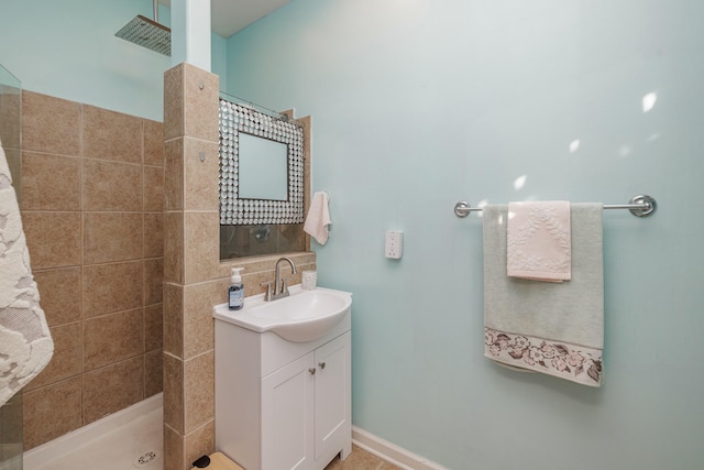 bathroom with vanity and a tile shower