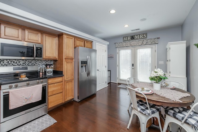 kitchen with stainless steel appliances, dark hardwood / wood-style floors, backsplash, and french doors