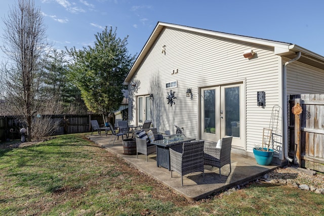 back of house featuring french doors, a lawn, and a patio area