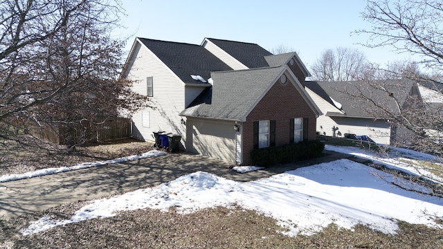 view of snow covered exterior with a garage