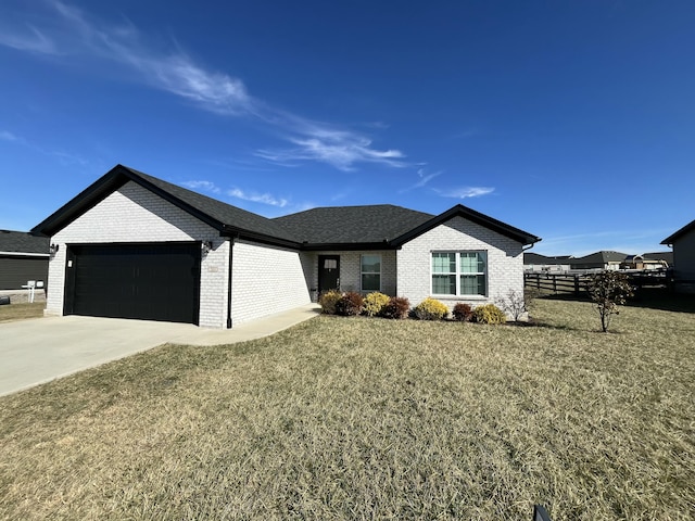 view of front of home with a garage and a front lawn