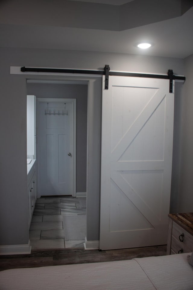 entryway with hardwood / wood-style flooring and a barn door