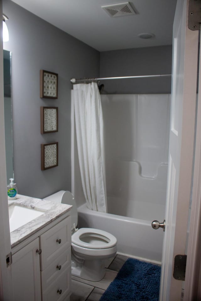 full bathroom with vanity, toilet, and shower / bath combo