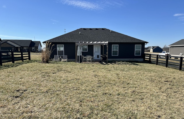 rear view of house with a yard