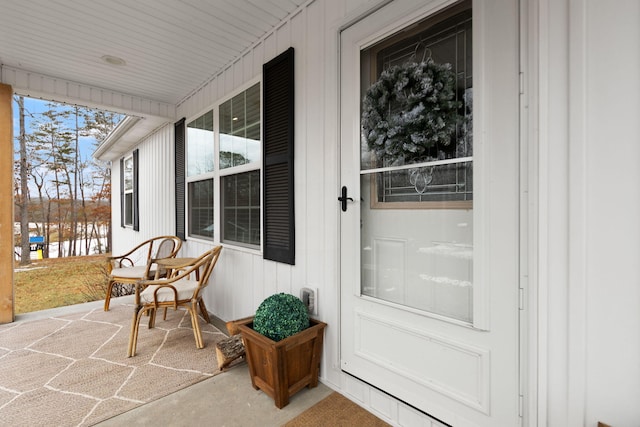 view of exterior entry featuring a porch