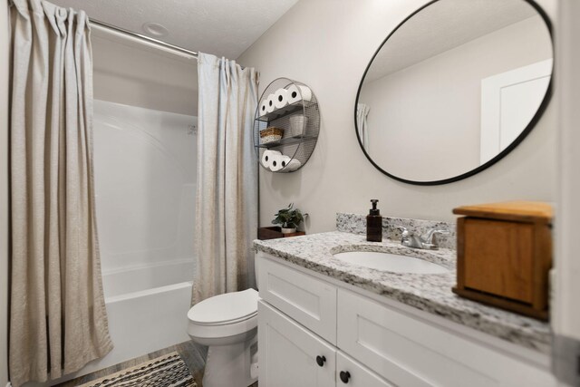 full bathroom featuring vanity, shower / tub combo with curtain, and toilet