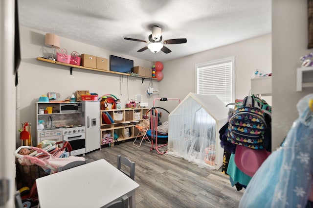 interior space with ceiling fan, hardwood / wood-style floors, and a textured ceiling