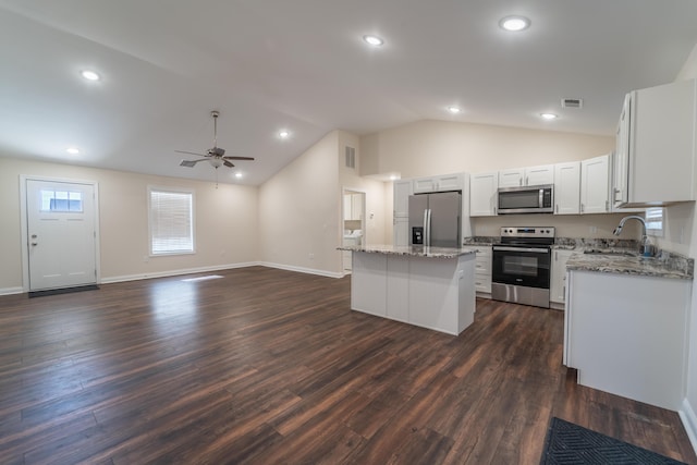 kitchen with dark wood-type flooring, sink, white cabinetry, a center island, and appliances with stainless steel finishes