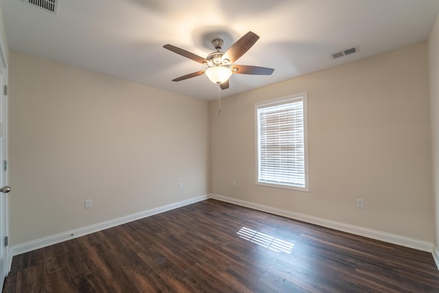 spare room featuring ceiling fan and dark hardwood / wood-style flooring