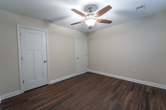 spare room with ceiling fan and dark hardwood / wood-style floors