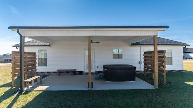 rear view of property featuring a yard, a patio area, and ceiling fan