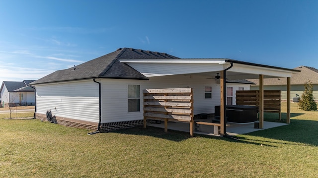 back of property with a yard, a patio area, and ceiling fan