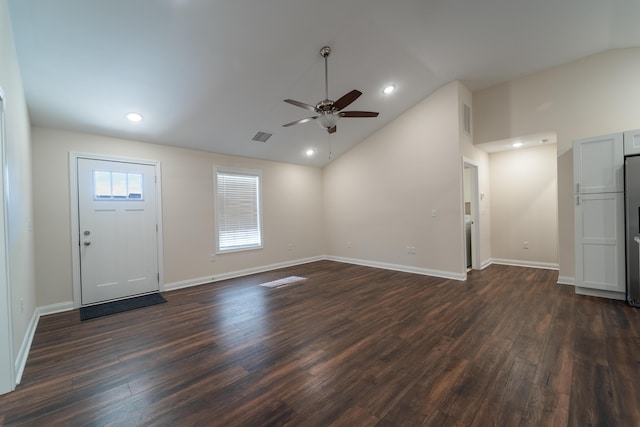 foyer entrance with dark wood-type flooring, ceiling fan, and vaulted ceiling