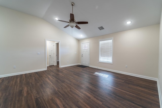 empty room featuring vaulted ceiling, dark hardwood / wood-style floors, and ceiling fan