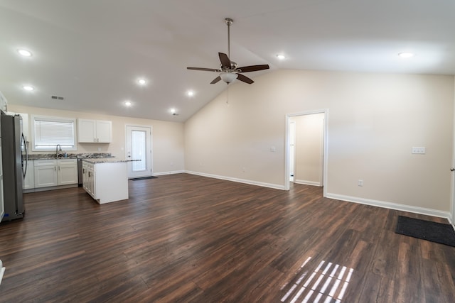 unfurnished living room with ceiling fan, lofted ceiling, dark hardwood / wood-style floors, and sink