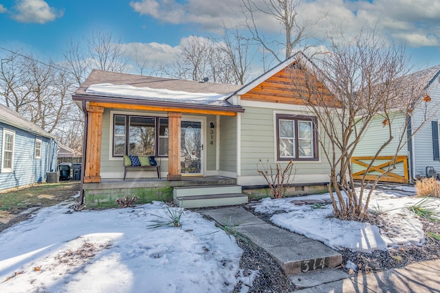 bungalow-style house with cooling unit and a porch