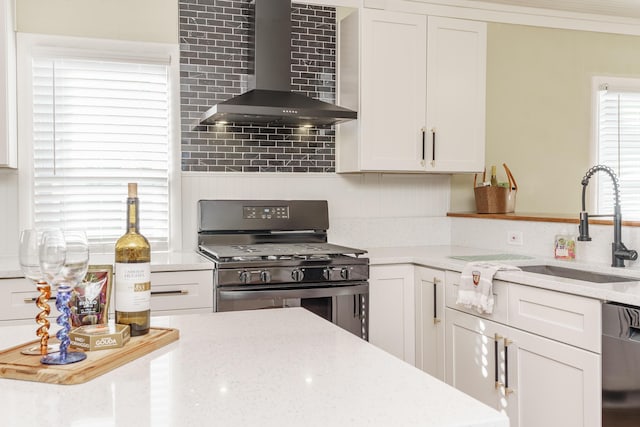 kitchen featuring black appliances, light stone countertops, white cabinets, and wall chimney exhaust hood