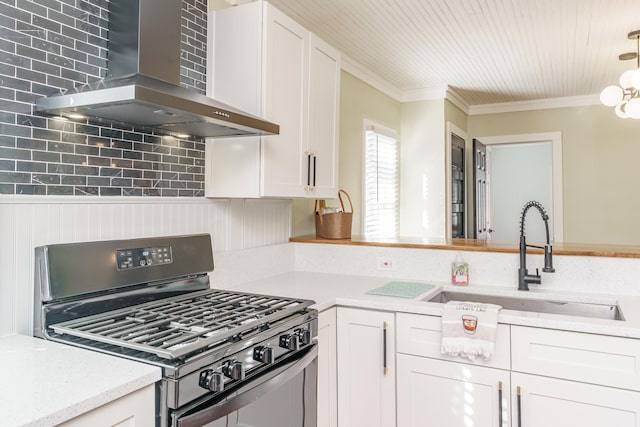 kitchen featuring black range with gas cooktop, sink, extractor fan, white cabinetry, and backsplash