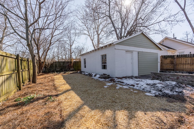 view of yard featuring a garage and an outbuilding